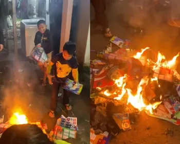 Crianças fazem fogueira com álbuns da Copa e vídeo viraliza