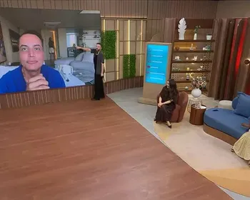 Homem vaza no fundo da imagem de Leo Dias, e apresentador fica sem graça