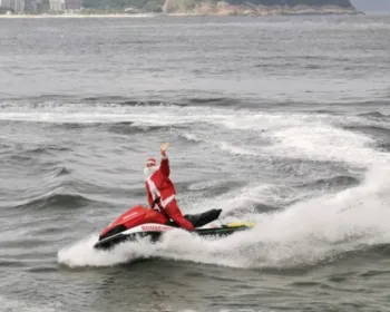 Papai Noel chega de moto aquática e distribui presentes no Rio