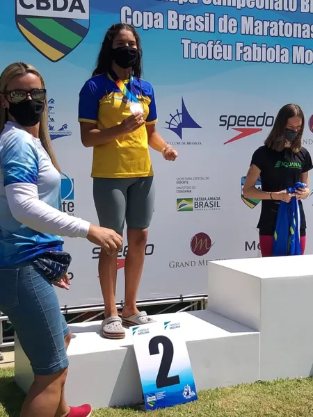 Prodígio na natação, Julia Fontes segura a medalha de prata e posa para a foto em Brasília/DF