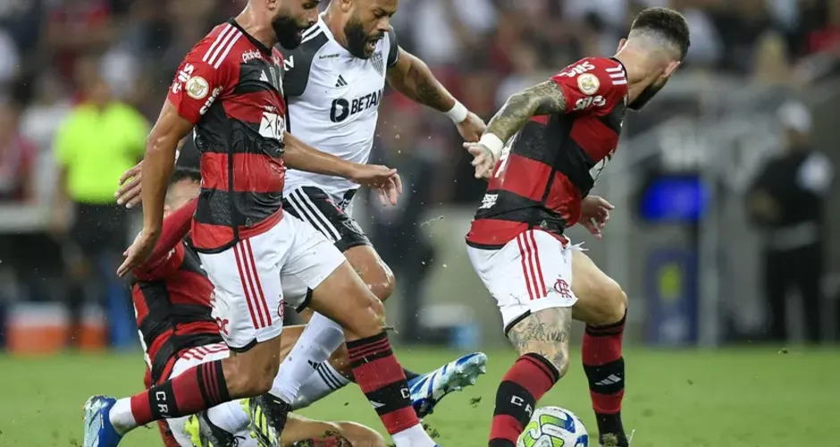 Mesmo cercado por três jogadores, Hulk (de branco) inferniza a defesa do Flamengo no Maracanã